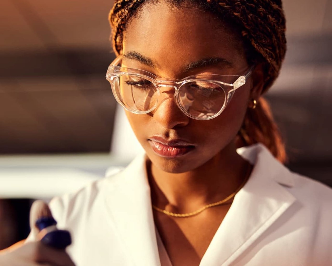 Female scientist, front view, holding a single-well pipette in the foreground, close up